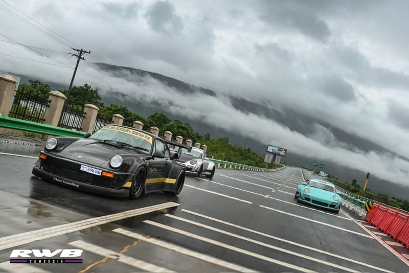 Three cars with dramatic clouds